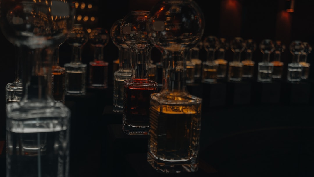 single malt whisky bottles lineup, whisky tasting glass amber
